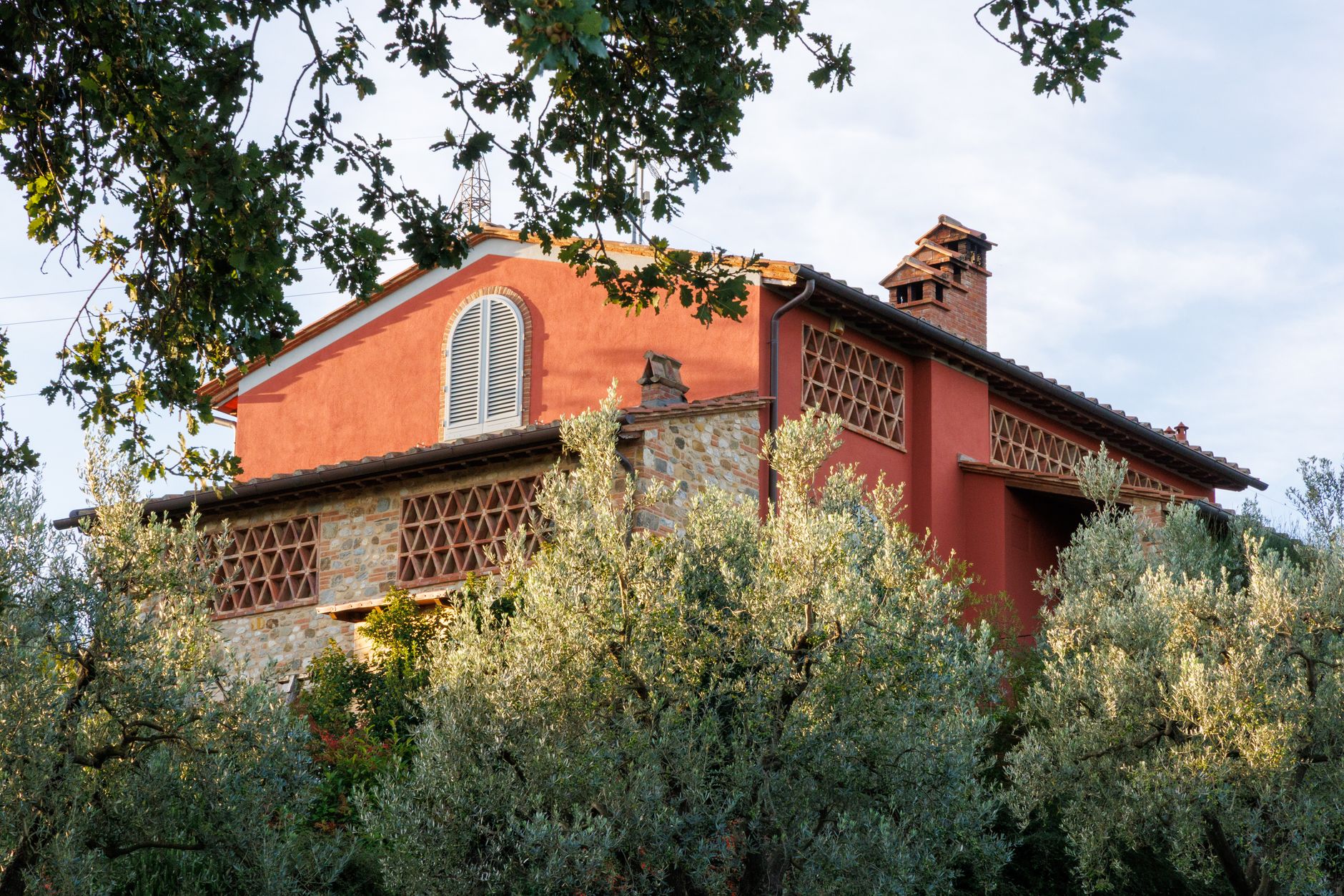 Sunlit wheat fields and stone farmhouse in Chianti